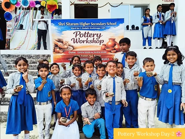 Students and guests gathered around pottery created during the school workshop